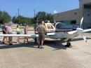 Brian Lloyd, WB6RQN (center, back to camera), supervises the loading of his aircraft "Spirit" for departure to Dominica this week.